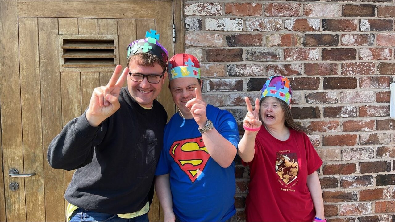 People smiling with party hats on