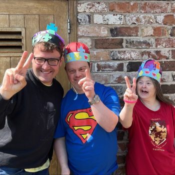 People smiling with party hats on