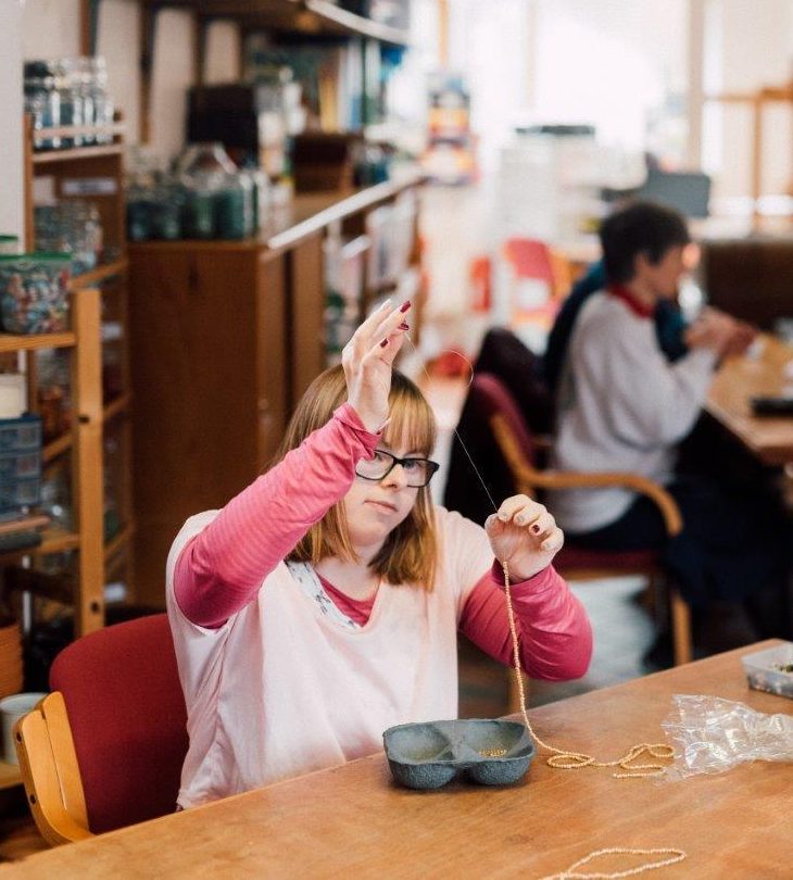 One of the people we support and staff member gardening outside in our day activities 