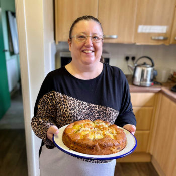 Gain confidence in cooking Lady holding a cake she has baked
