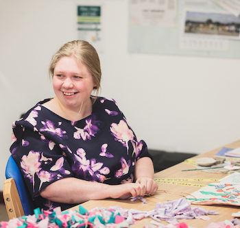 Gain confidence in creativity Lady smiling at the camera in art studio