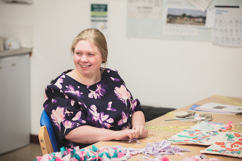 Lady smiling at the camera in art studio