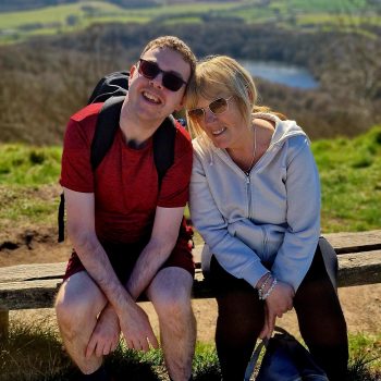 2 people sitting on a bench
