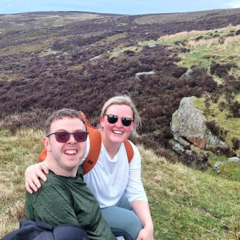 2 people walking and smiling outside