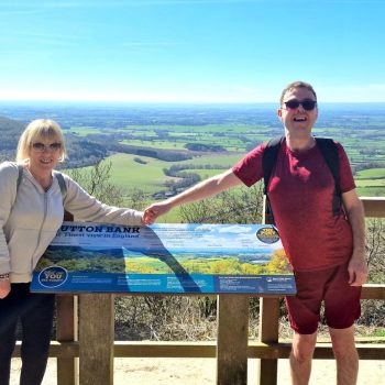 2 people standing in the countryside