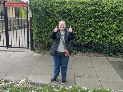 Hannah standing in front of a school
