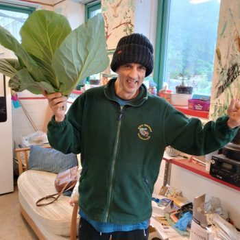 A person we support holding a cabbage