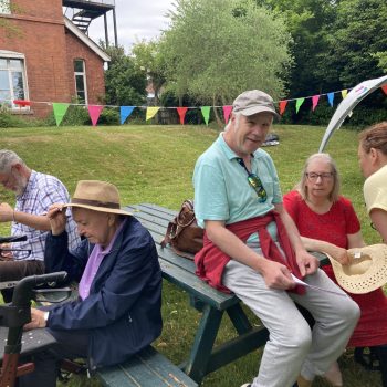 People sitting on benches at Grange Fest