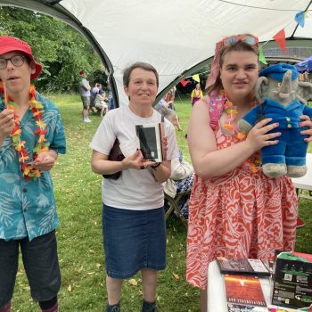 Three people standing at a festival