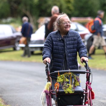 A person we support walking with a walker