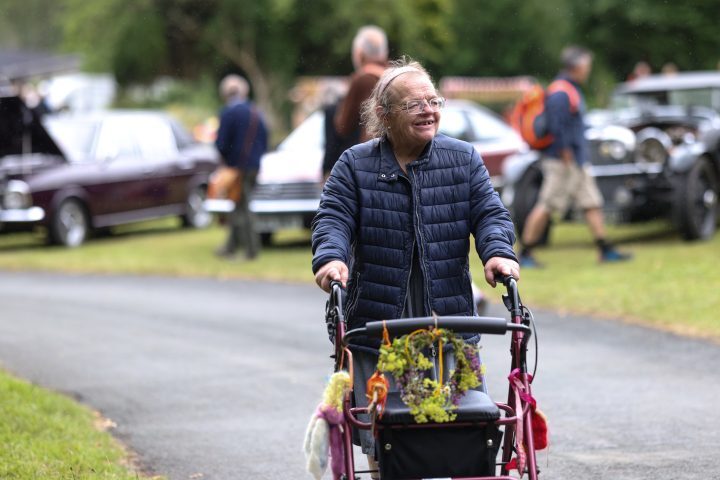 A person we support walking with a walker