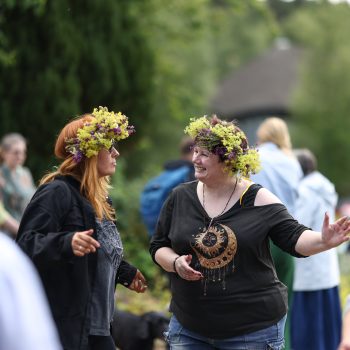 People dancing with flower crowns