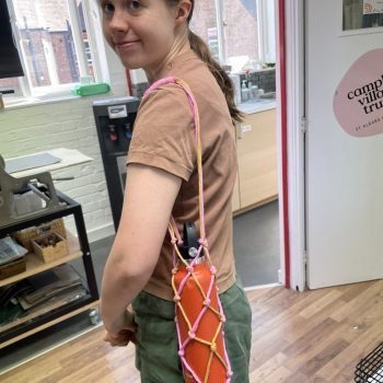 A macrame water bottle holder