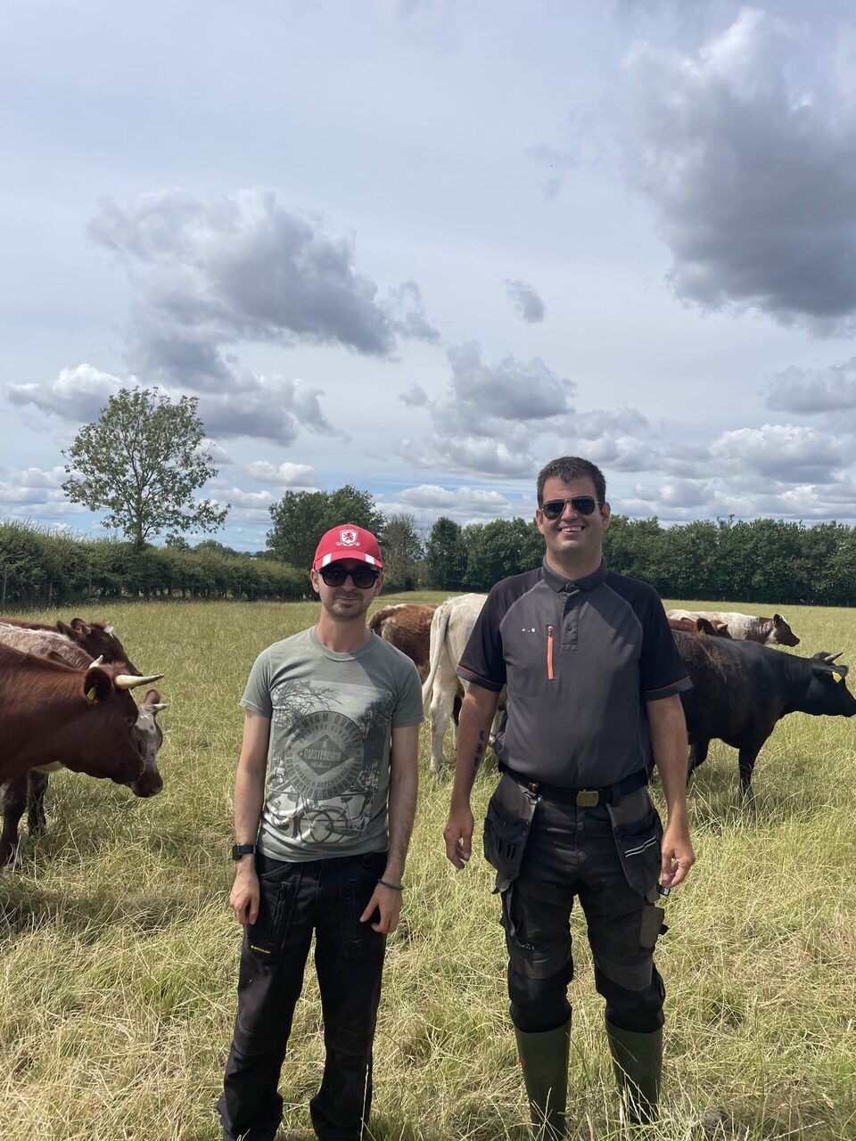 Two people standing outside in our social farm
