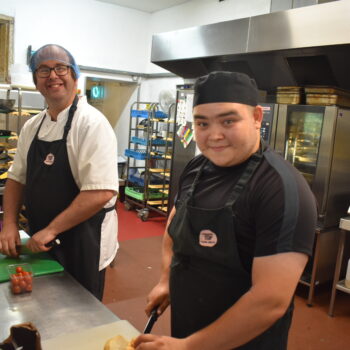 Two people cooking