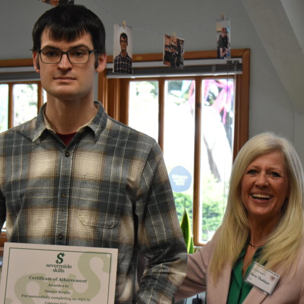 Howard And Sara Thakkar Howard holding a certificate