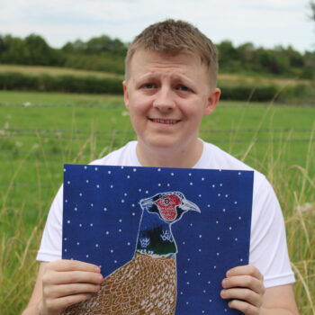 Liam holding his card