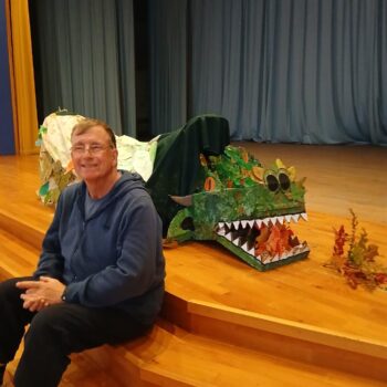 A person we support with the dragon puppet