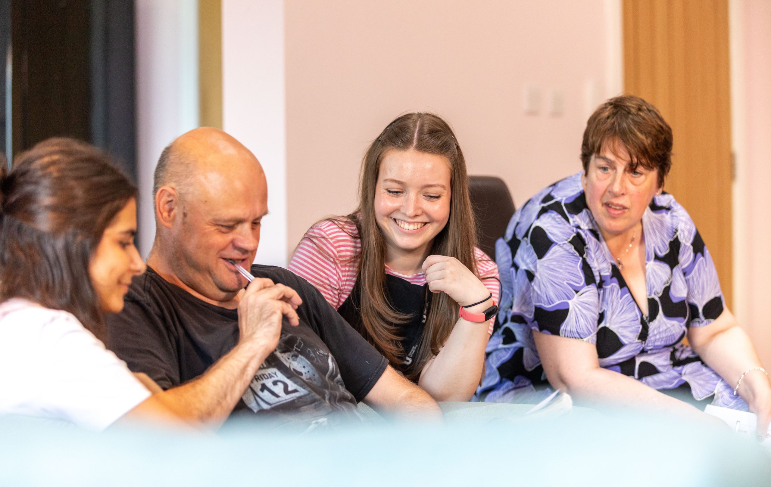 Jenna, Michael, Megan and Debbie tick actions off their visual "physical activity" bingo cards