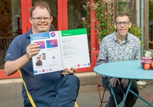 Members of the digital inclusion group show the easy read guides they co-produced