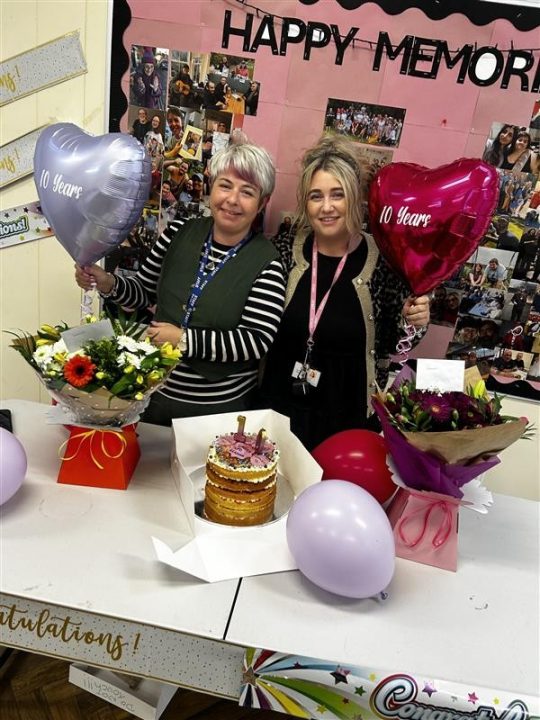 Leanna and Lauren with balloons and a cake