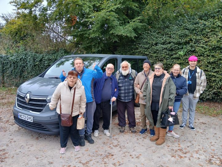 A group of people from the Stourbridge community stand in front of a new minivan, they look happy!