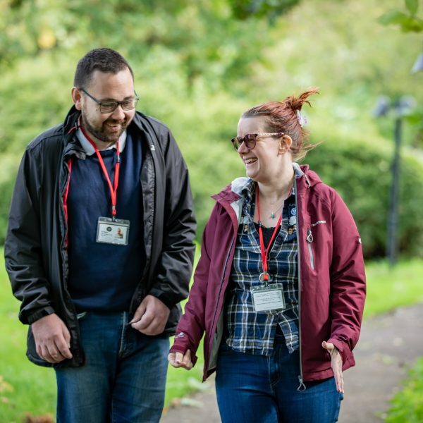 People we support standing next to a minubus