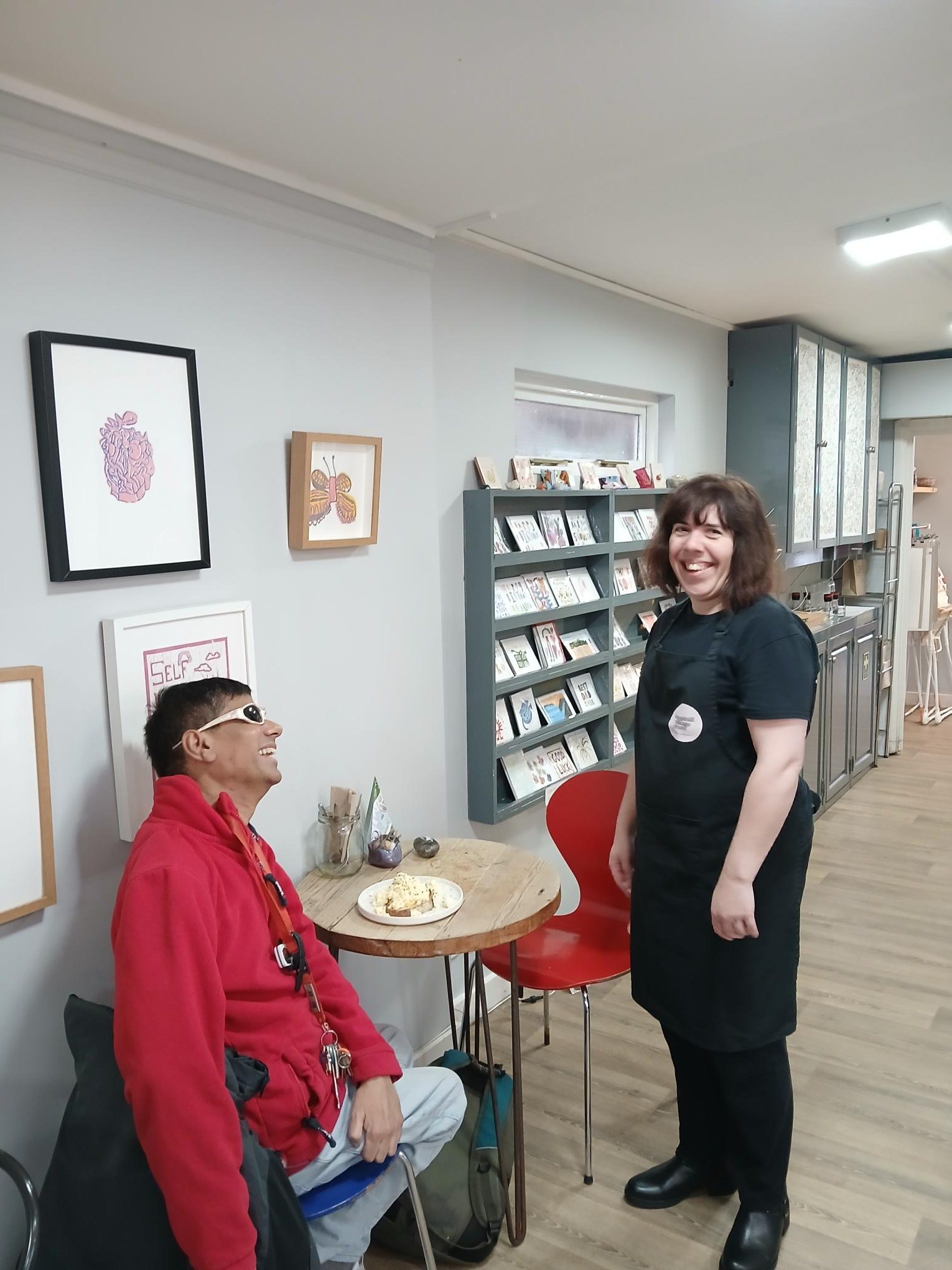 A person we support working in the Cafe