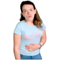 A woman holds her stomach, she is having tummy cramps.