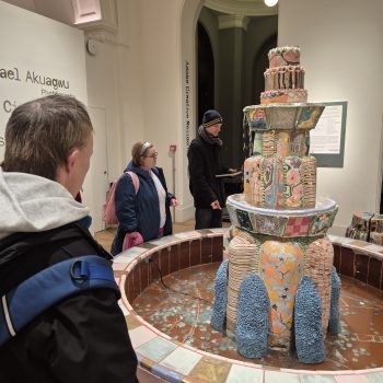 People looking at an art piece