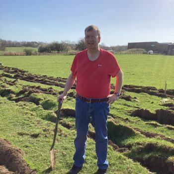 A person standing with a shovel