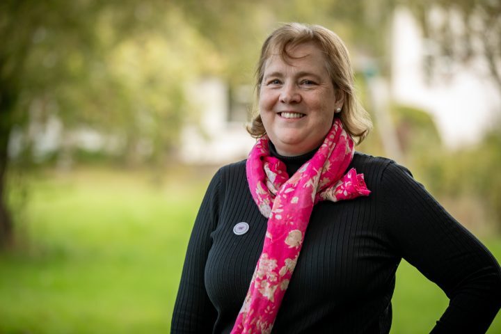 Dr Ann Kenney Trustree she is standing outside, smiling at the camera.
