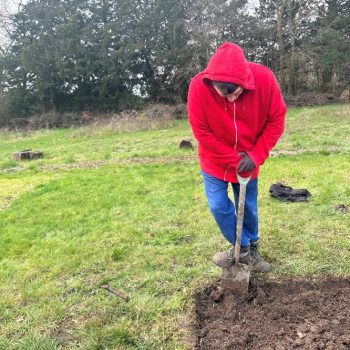 A person digging outside