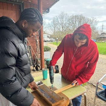 Someone making a wooden sign