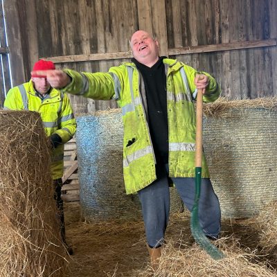 Michael laughing in a farm