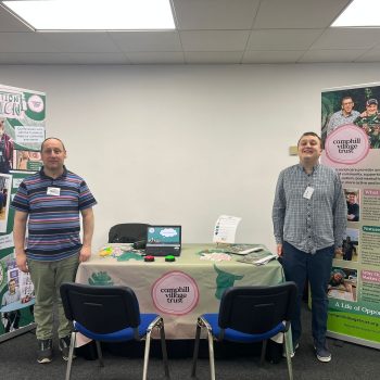 Simon and Paul standing next to their stand