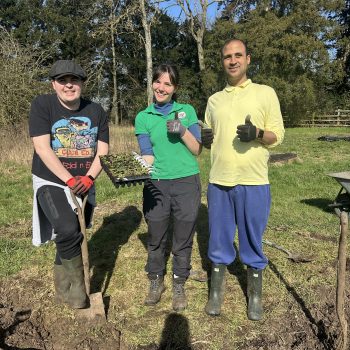 people smiling with plants