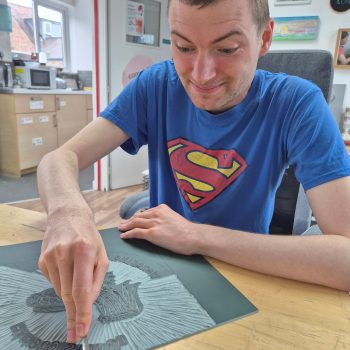A person doing lino printing