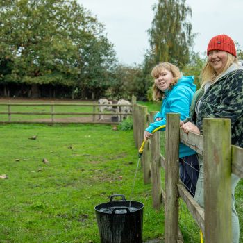 Amy and support worker filling water bucket