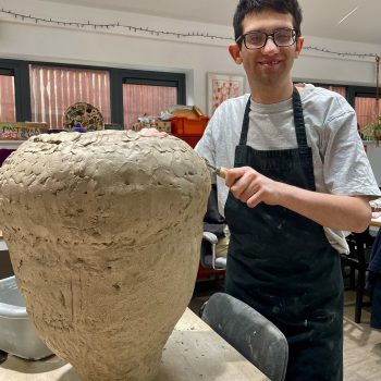 A person making a big vase