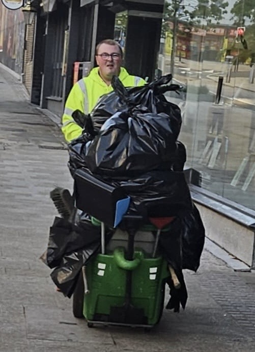 Sean pushing a cart of big bags