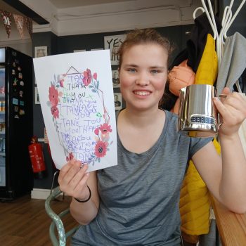 A person holding a milk frother