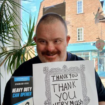 A person holding a thank you card