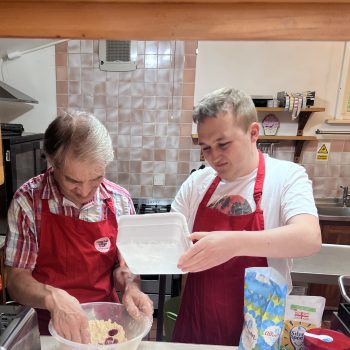 Two people cooking food