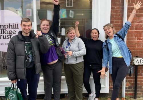 People smiling outside the cafe