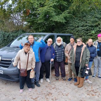 People standing with a minivan