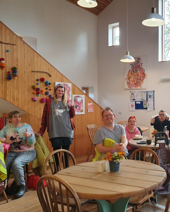 People sitting in a cafe smiling