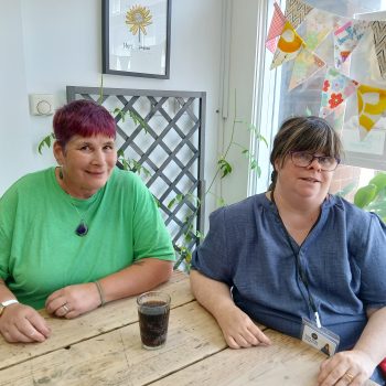 Two people sat in a cafe